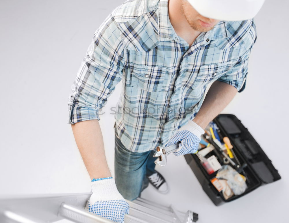 Similar – Man with a dust mask and goggles working on a circular saw