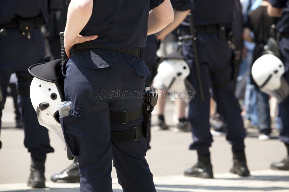 Similar – armed policeman with handcuffs from behind, partial view