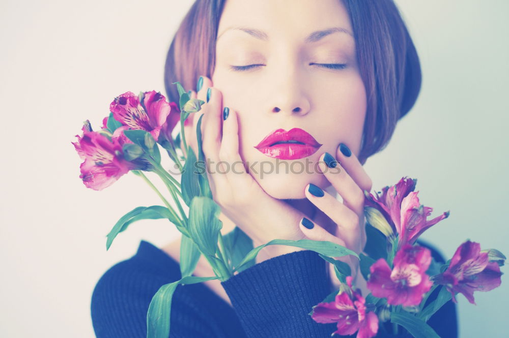 Young woman hugging a bouquet of flowers