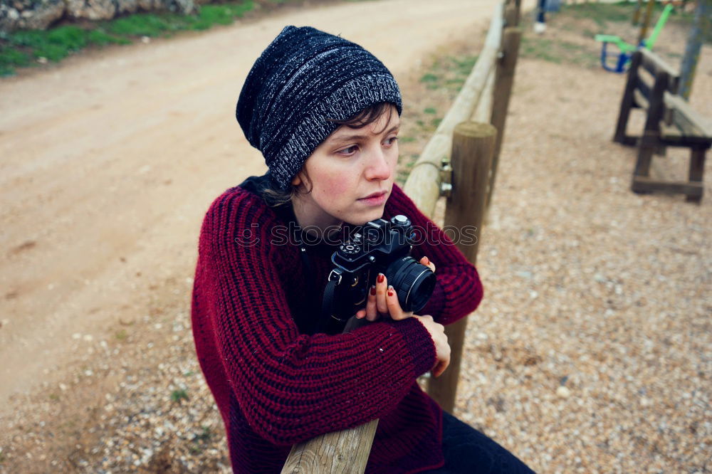 Teen alone in a park with her camera