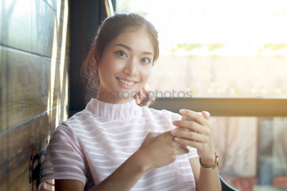 Similar – Image, Stock Photo Girl sitting in a street bar looking at her smartphone