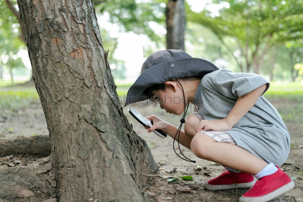 Similar – Image, Stock Photo boy exploring the outdoors with binoculars