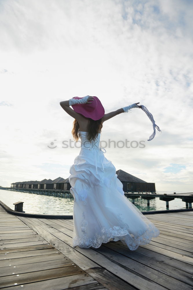 Similar – Image, Stock Photo Pensive bride with a red suitcase on the train tracks