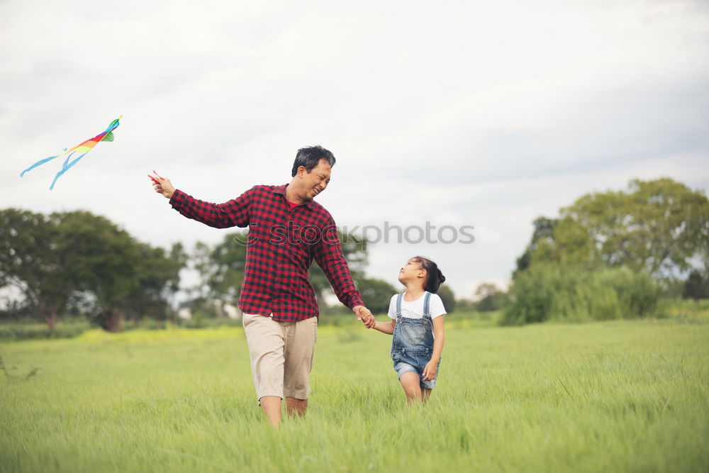 Similar – Image, Stock Photo Father and son playing at the park near lake at the day time.