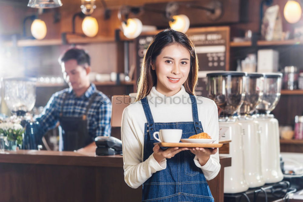 Similar – smiling Barista girl prepares coffee