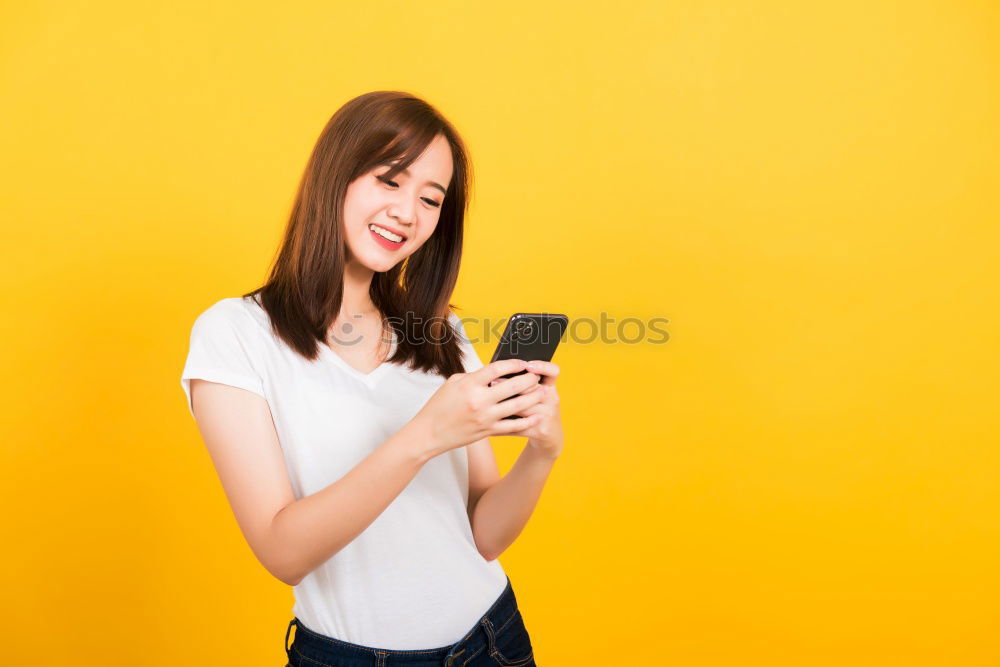 Similar – Portrait of beautiful young woman using mobile phone in the street.