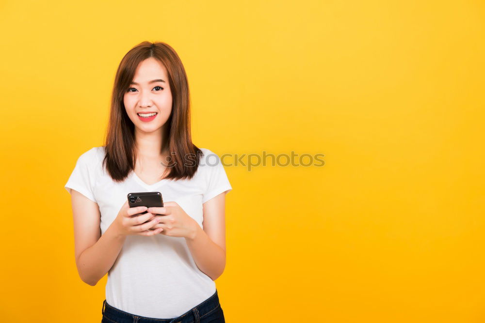 Similar – Portrait of beautiful young woman using mobile phone in the street.