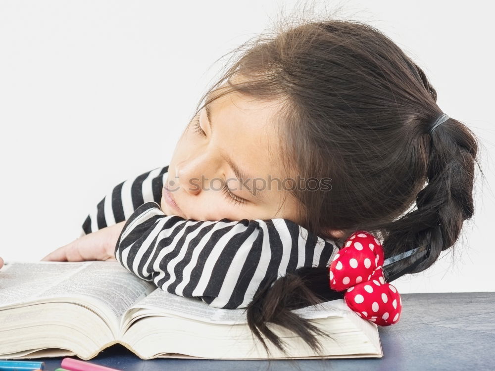 Similar – Image, Stock Photo Little girl doing homework on bed at home