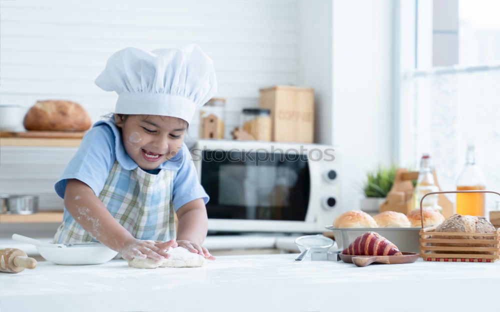 little african girl making cupcakes in kitchen