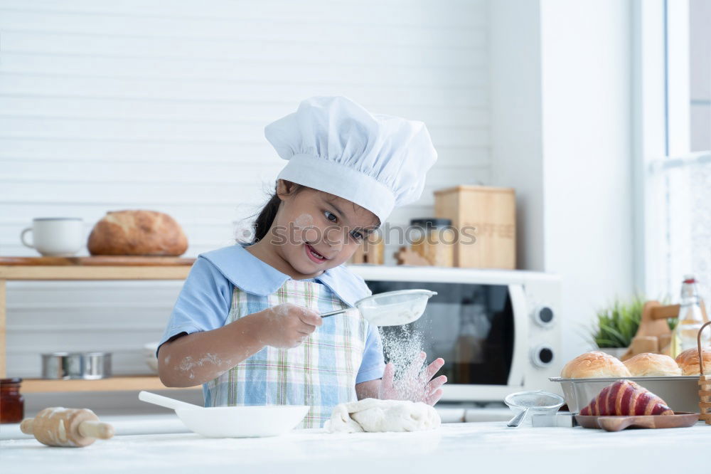 Similar – little african girl making cupcakes in kitchen