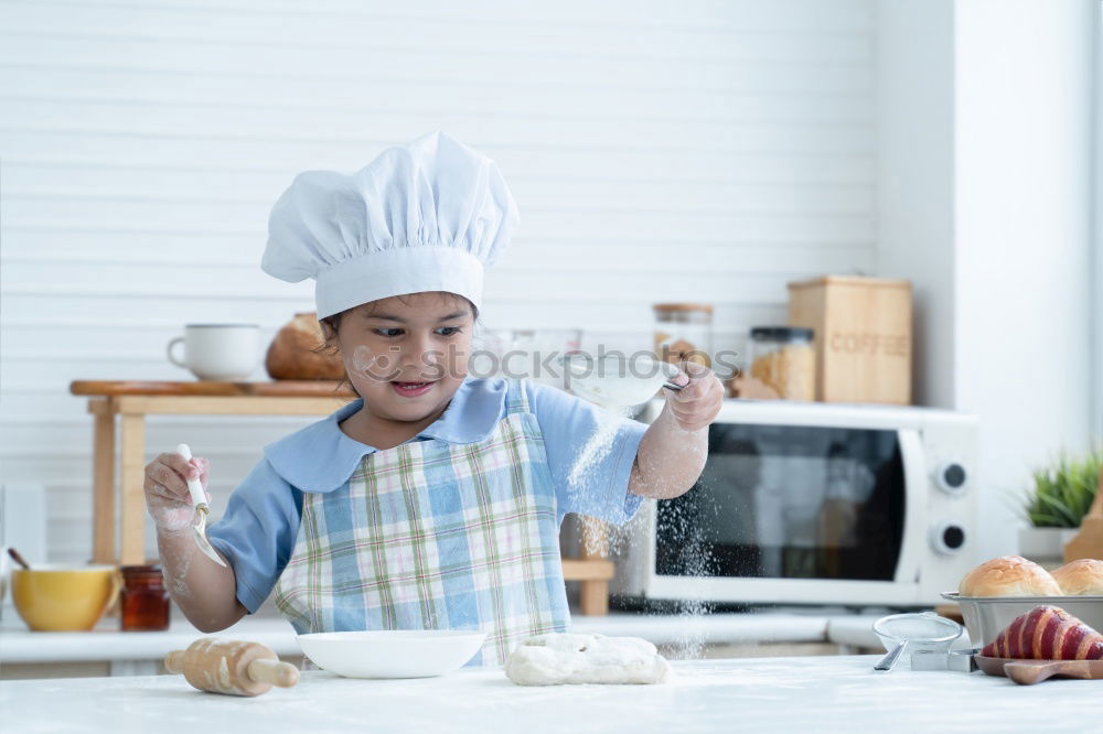 Similar – Boy in cook hat in kitchen