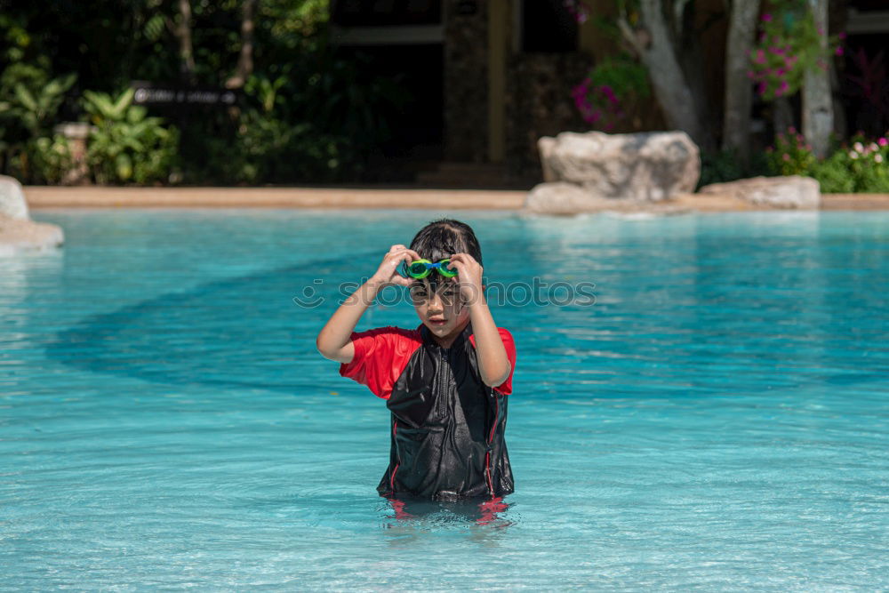 Similar – junge Frau im Pool hält ein Glas Weißwein in die Höhe während ihr das Wasser bis zum Hals steht