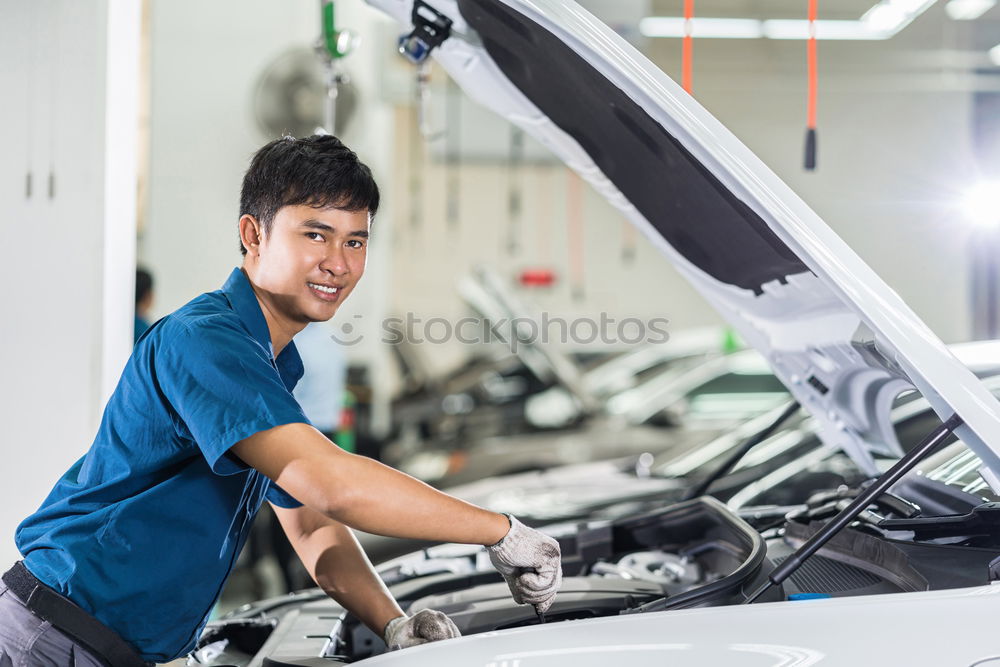 Similar – Professional Mechanic Repairing Car.