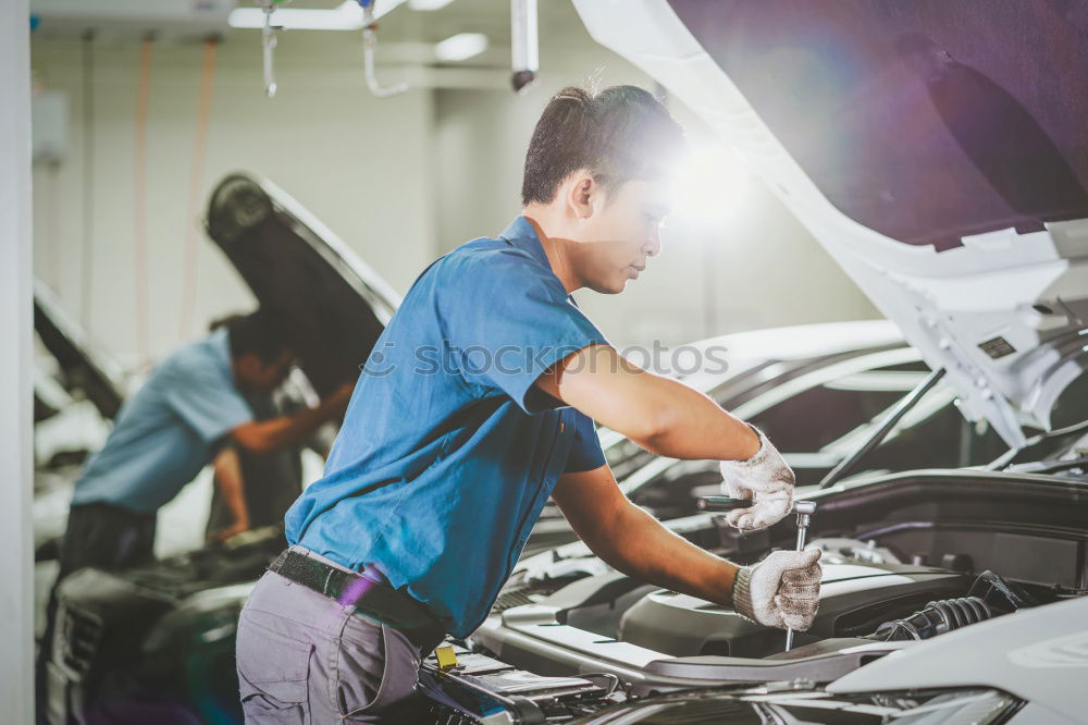 Similar – Professional Mechanic Repairing Car.