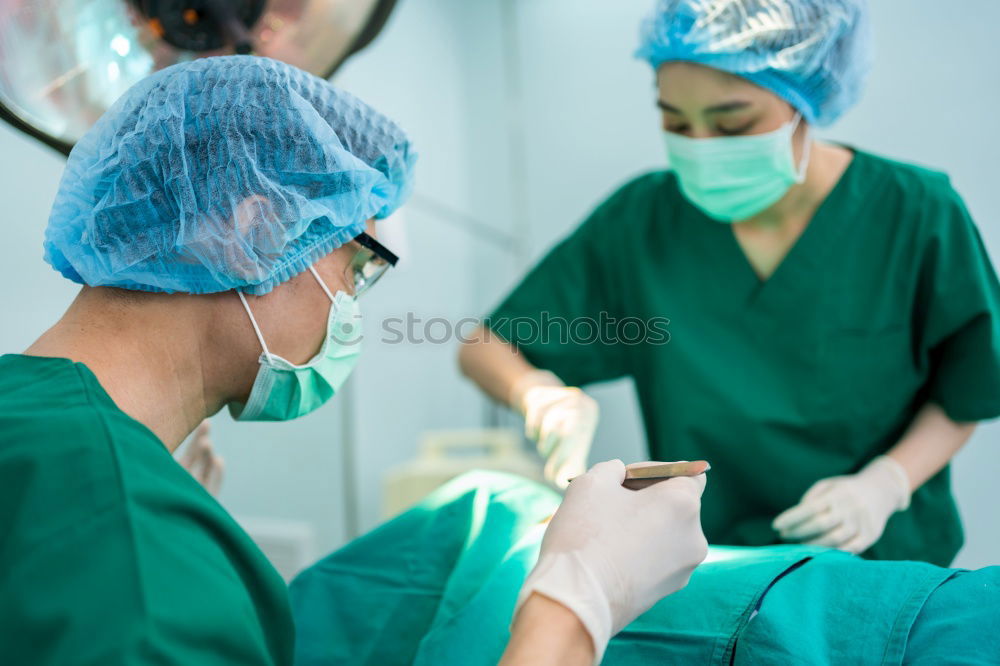 Similar – Image, Stock Photo Team of Surgeons Operating.