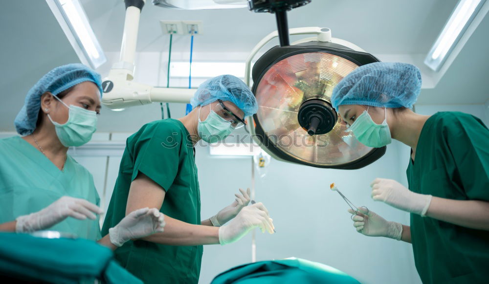 Similar – Image, Stock Photo Team of Surgeons Operating.