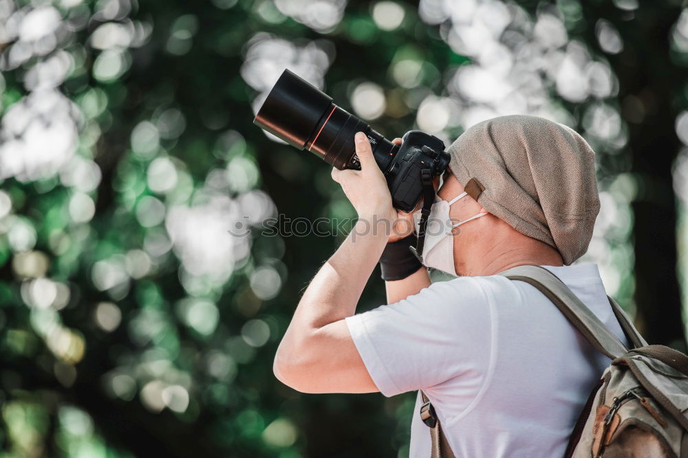 Similar – Hand taking shot of forest