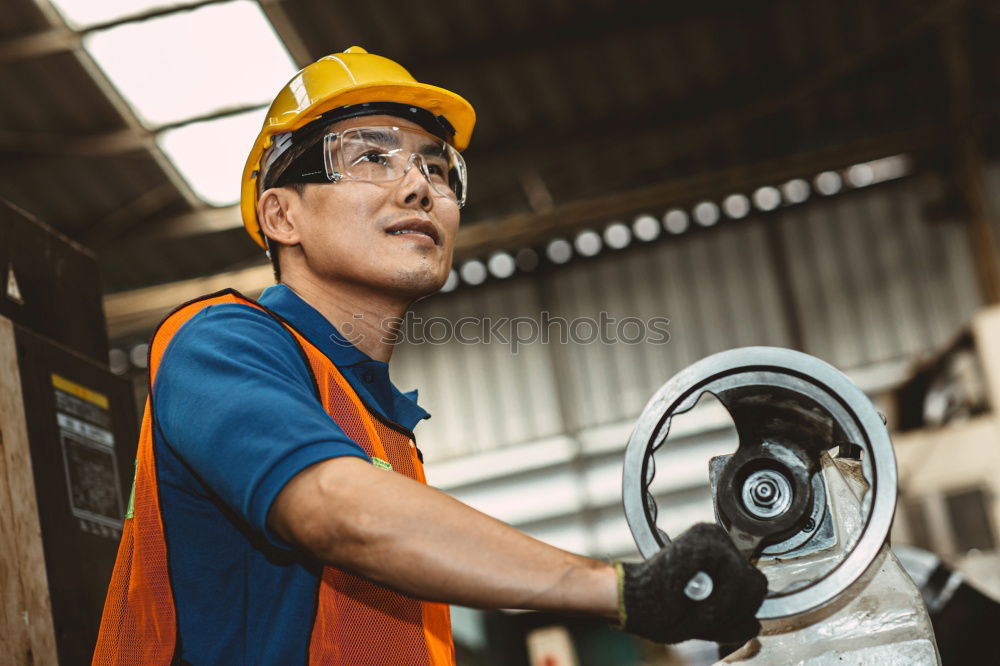 Similar – Professional Mechanic Repairing Car.