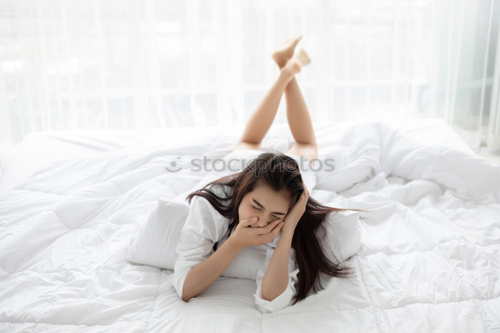 Similar – Image, Stock Photo Young girl looking at mobile phone while sitting on bed