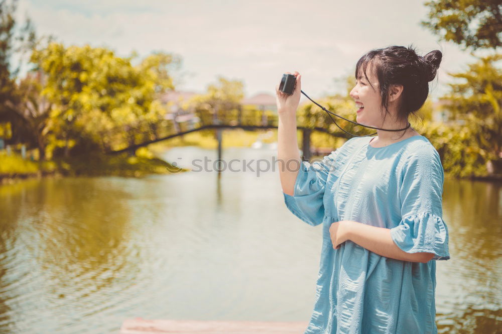 Similar – Pretty Asian woman sitting at pond