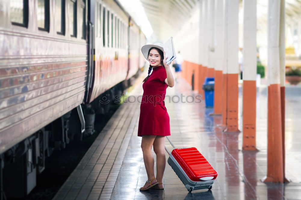 Similar – Fröhliches Mädchen steigt am Bahnhof mit Kaffee in der Hand in den Zug ein.