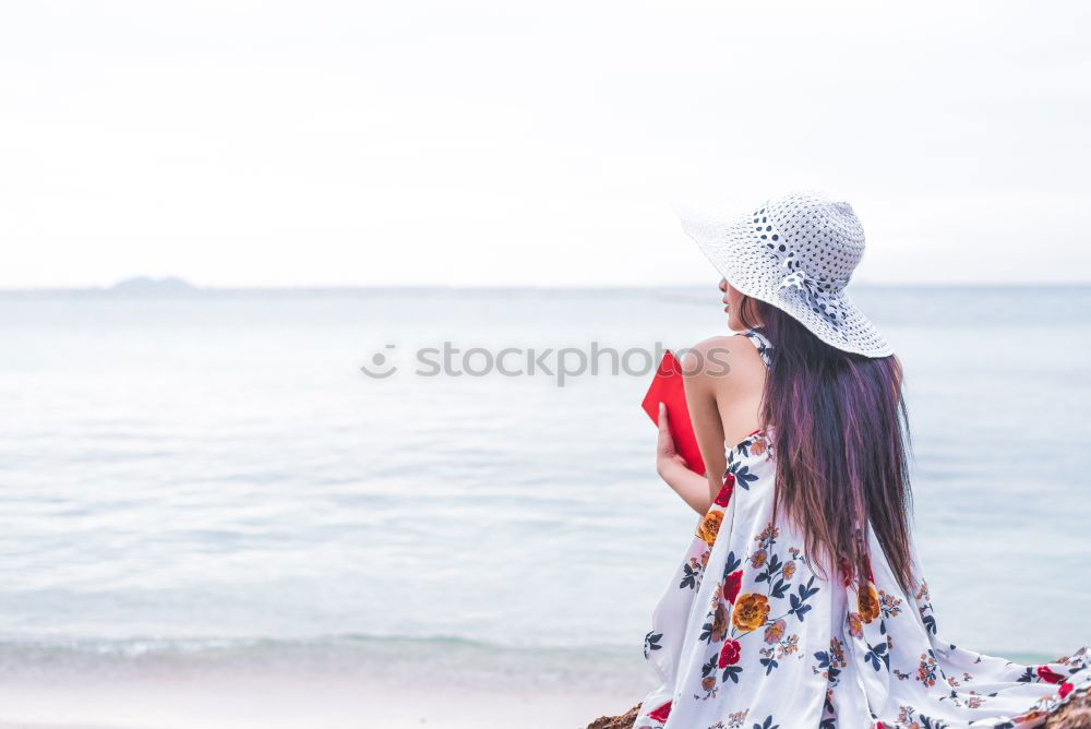 Similar – Woman on the beach looking at the horizon