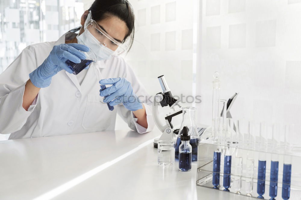 Similar – Worker putting liquid to test tube