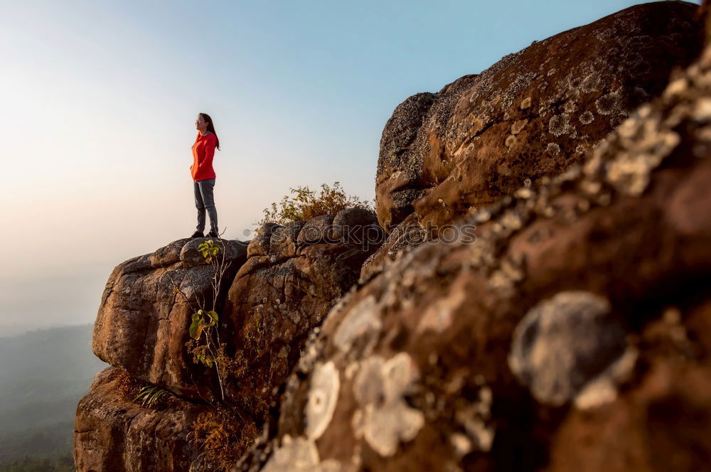 Similar – Man sitting on cliff