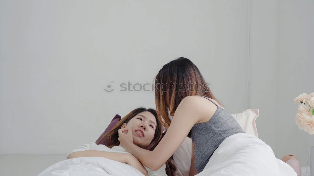 happy mother and child son playing pillow fight