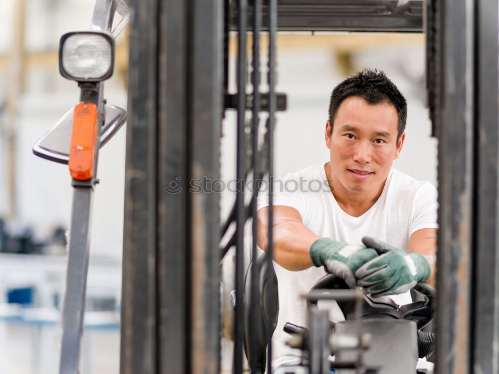 Similar – Professional Mechanic Repairing Car.