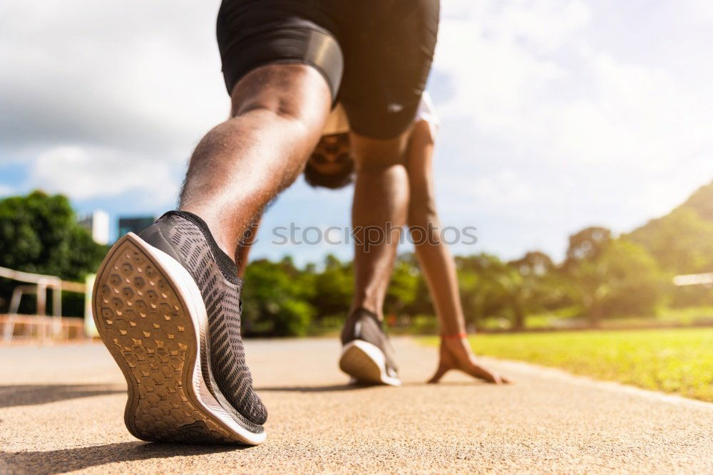 Similar – Runner get ready for run, tying sneakers shoelaces