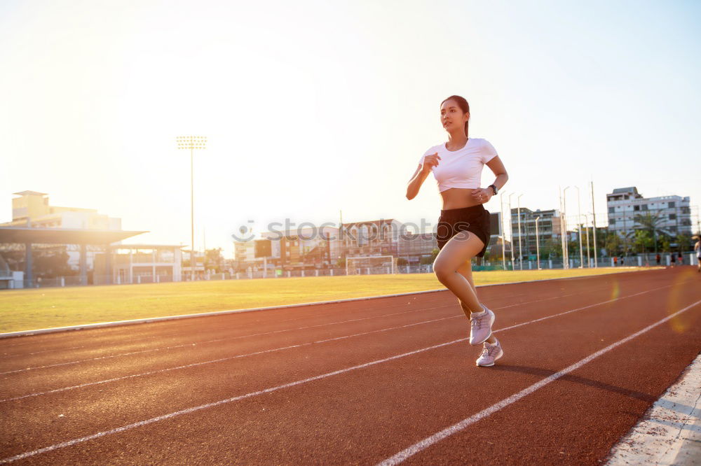 Similar – Young fitness woman runner running on city bridge.