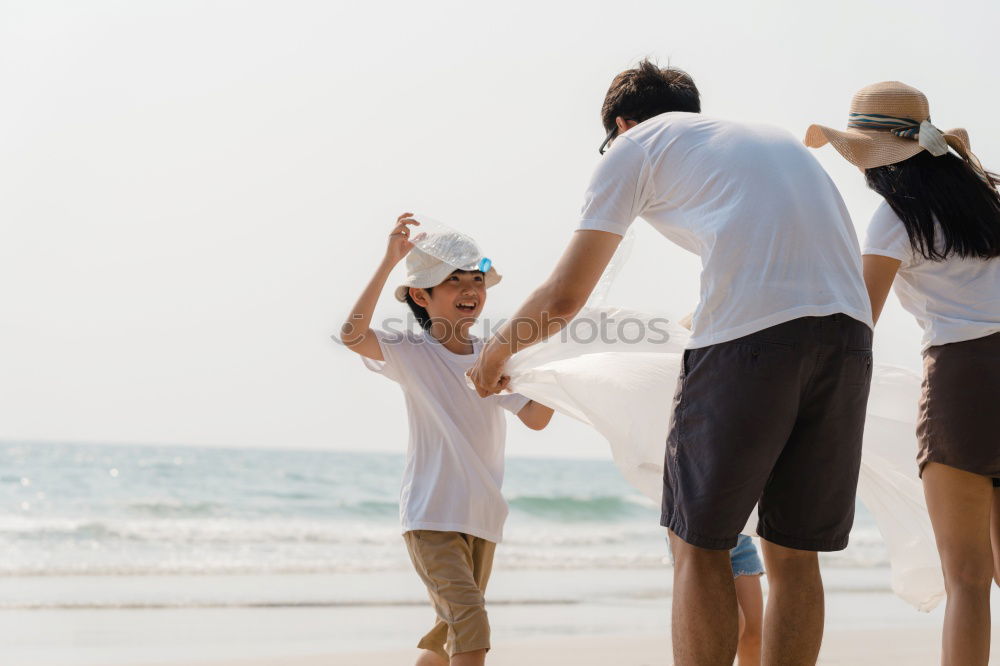 Similar – Father and daughter with balloons playing on the beach