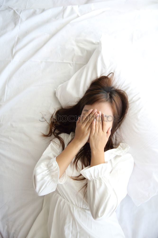 Similar – Portrait of an attractive, young, sexy dark haired woman in Bed, hand and head on the pillow under the blanket, Copy space.