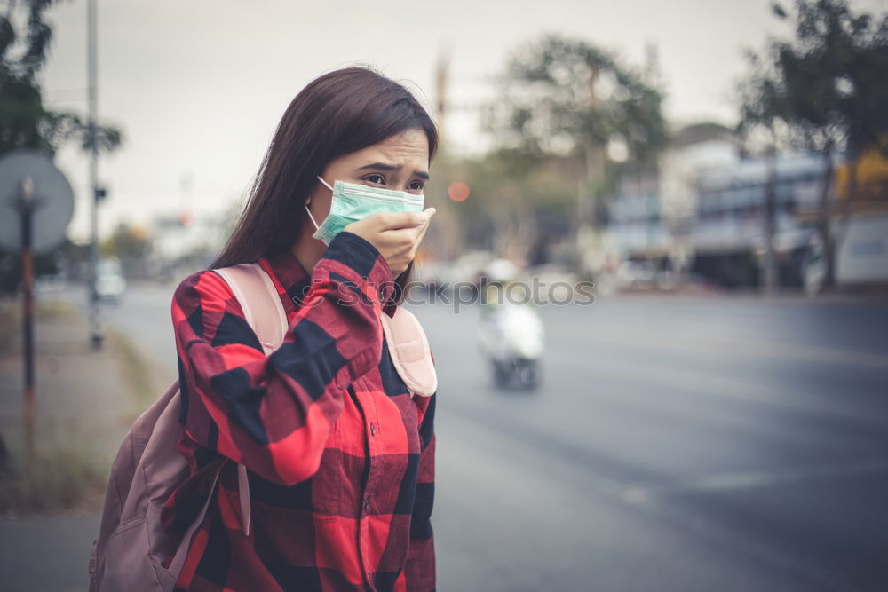 Similar – Young woman in medical mask standing near blooming flowers