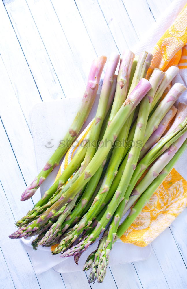 Similar – Image, Stock Photo Fresh raw asparagus spears on a white table