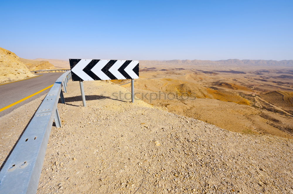 Similar – Warning sign in curve in front of alpine panorama