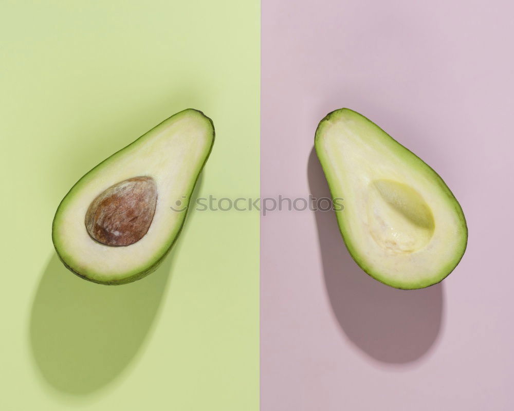 Similar – Cut avocado on white plate on pastel background