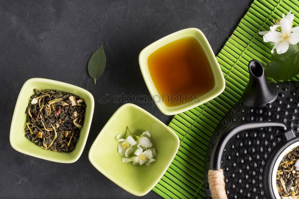 Similar – Black tea with jasmine in a white cup on a brown wooden table