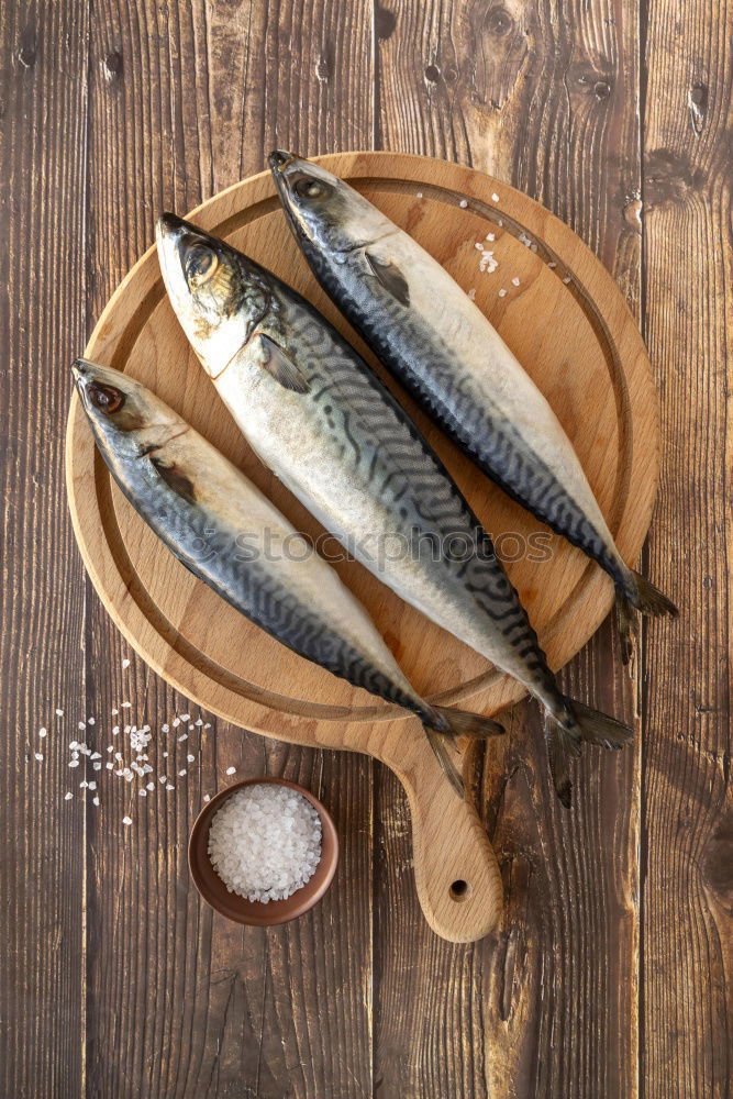 Similar – Image, Stock Photo Fresh smelt fish in spices for cooking on a kitchen board