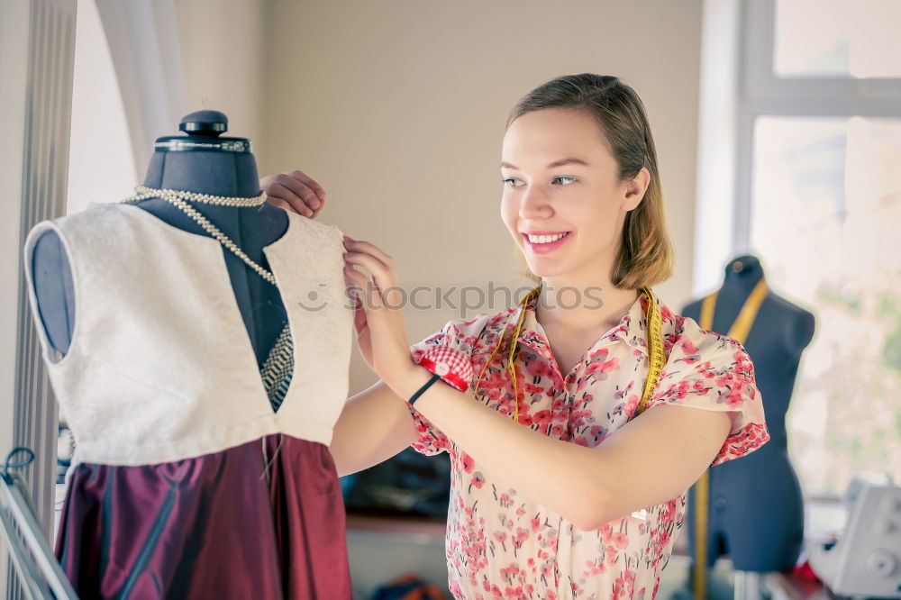 Similar – Young woman hanging clothes on coat hanger