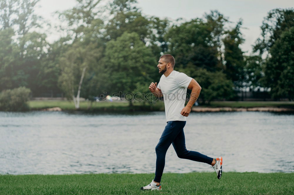 Similar – A long hair male running between the trees during a sunny day in the park with copy space