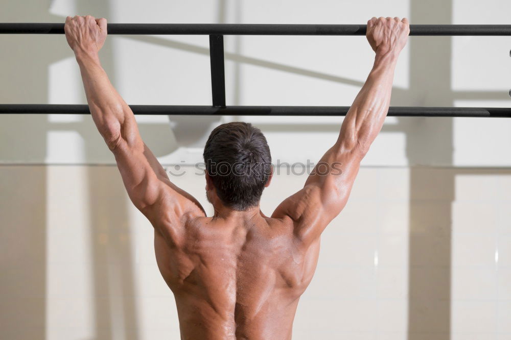 Similar – Young man stretching a resistance rubber band before calisthenics training