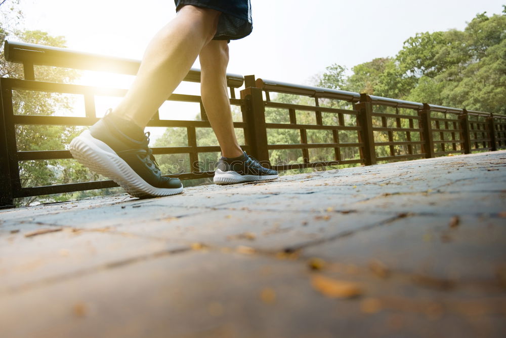 Similar – Young woman jogging down an autumn street