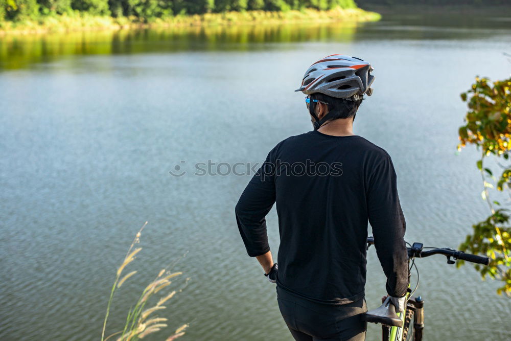 Similar – Cyclist Riding a Bike at sunset. Sports