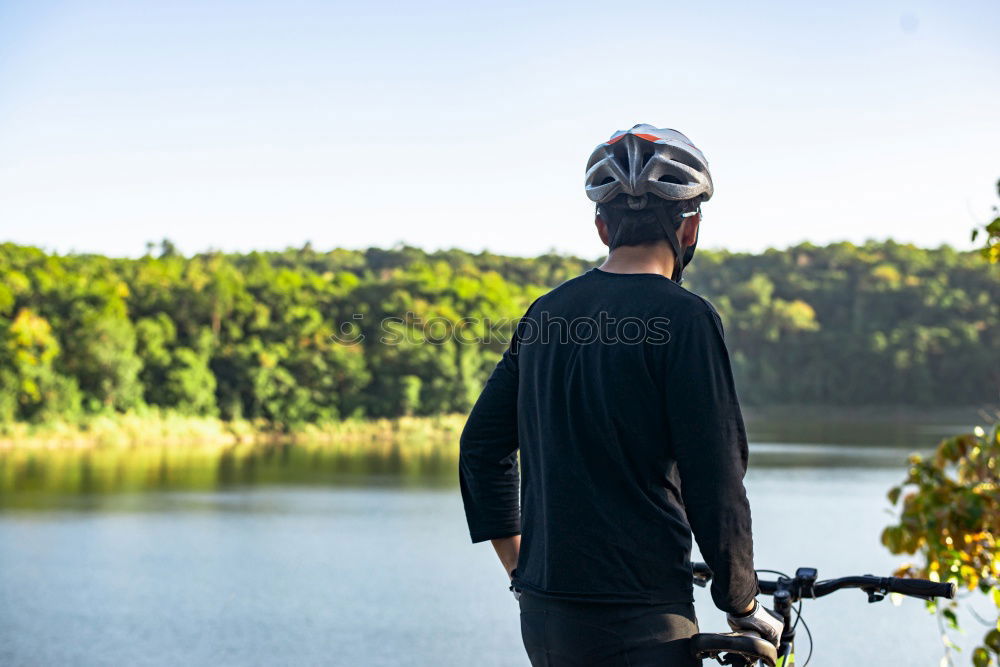 Similar – Cyclist Riding a Bike at sunset. Sports