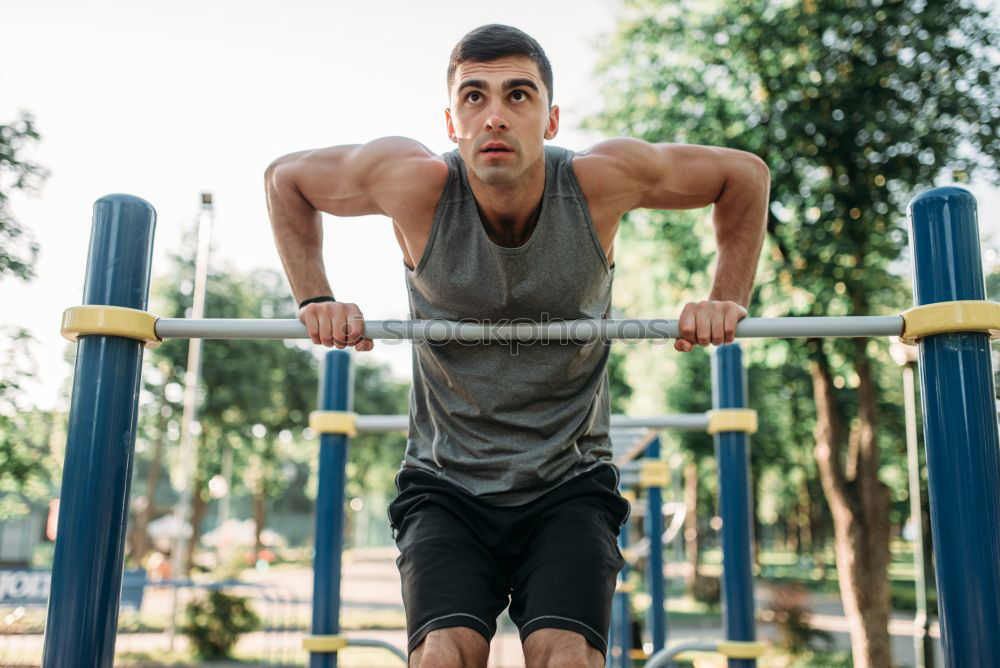 Similar – Athletischer junger Mann beim Vorbereiten und Kontrollieren von Gymnastikringen