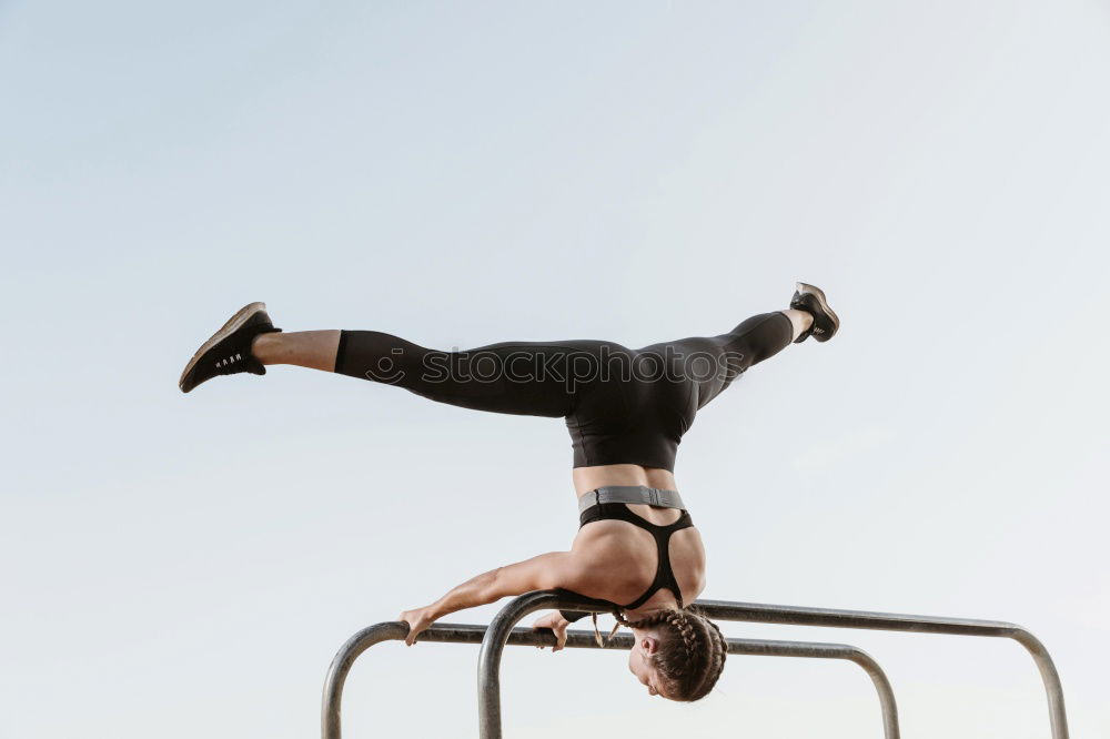 Similar – Athletic man balancing on gymnastic rings