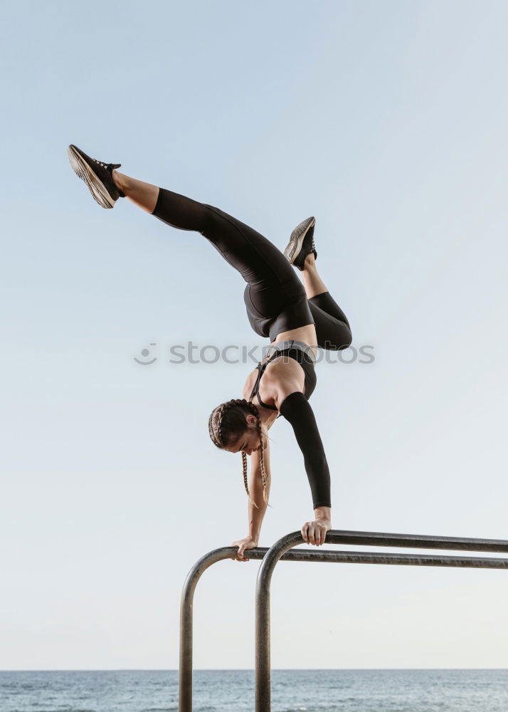 Similar – Athletic man balancing on gymnastic rings