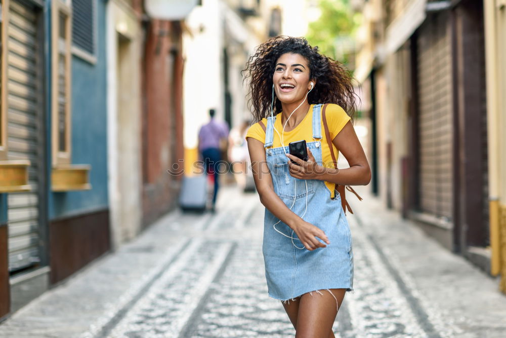 Similar – Young black woman drinking coffee wandering in the streets of Madrid on winter